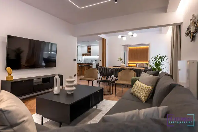 Φωτογράφιση διαμέρισμα Airbnb, καθιστικού με καναπές και θέα τη τραπεζαρία και τη κουζίνα.